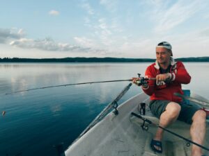 Angler fishing from a kayak in shallow coastal water